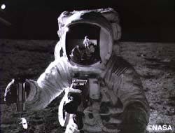 アポロ12号で月着陸した際に、宇宙船外活動をするビーン。手に持っている特殊環境サンプル容器には、集めた月の土が入っています(c)NASA